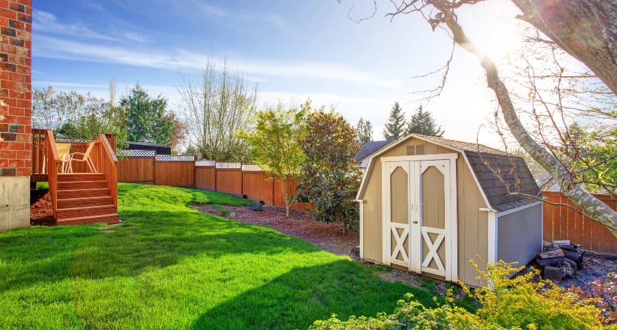 Fenced backyard with storage shed in Ocala